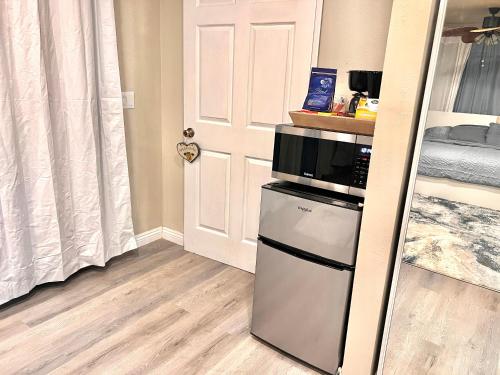 a kitchen with a refrigerator and a microwave at Cozy Room with Private bathroom & Entrance in Carson