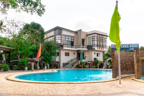 a swimming pool in front of a building at PATIO BUENDIA FARM RESORT AND EVENTS PLACE in Amadeo