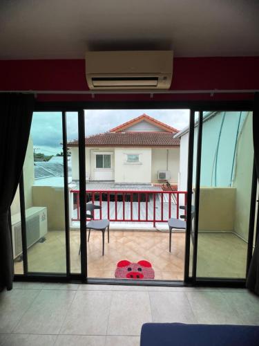 a view of a balcony from a room with a window at Petunya Room 2 in Ban Huai Luk (1)