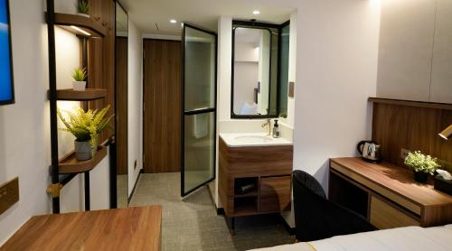 a bathroom with a sink and a mirror at ST Signature Bugis Middle, SHORT OVERNIGHT, 11 hours 8PM-7AM in Singapore
