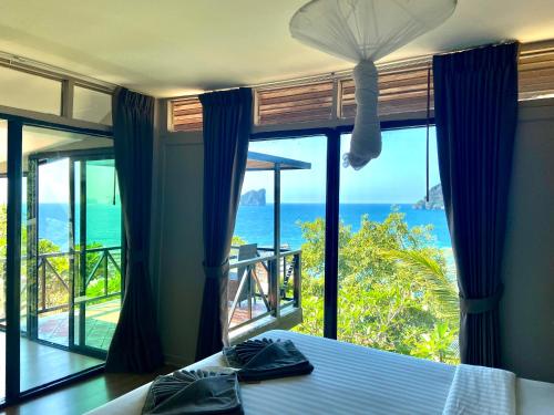 a bedroom with a bed and a view of the ocean at HIP Seaview Resort @ Phi Phi in Phi Phi Don