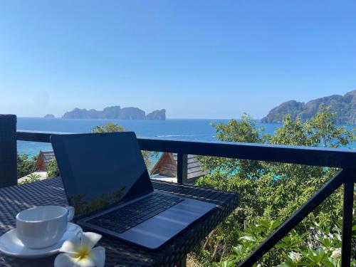 a laptop computer sitting on a table on a balcony at HIP Seaview Resort @ Phi Phi in Phi Phi Don