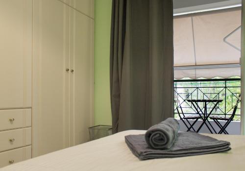 a bedroom with a bed and a window with a table at Gtrip Ellinikon Experience Apartment - 31506 in Athens