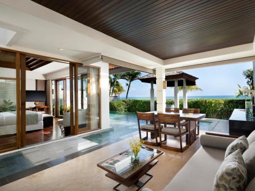 an open living room with a view of the ocean at The Seminyak Beach Resort & Spa in Seminyak
