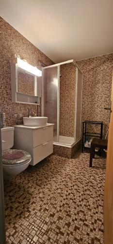 a bathroom with a toilet and a sink and a shower at Waldrand Haus B 4. Stock in Bellwald