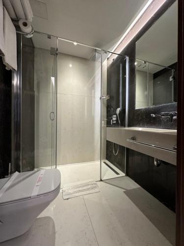 a bathroom with a glass shower and a toilet at Henna Hotel Istanbul in Istanbul