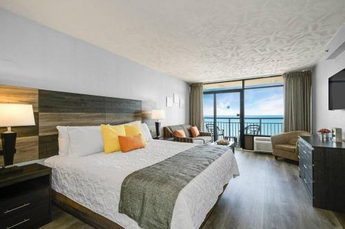 Habitación de hotel con cama y vistas al océano en Spacious King Oceanfront Studio Suite Full Kitchen 1026, en Myrtle Beach