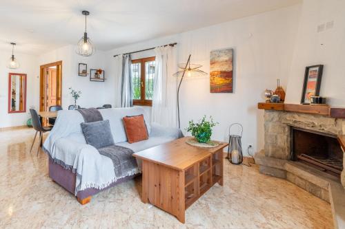 a living room with a couch and a fireplace at La Boniquesa in Benissa