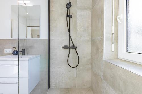 a shower with a shower head in a bathroom at AUSZEIT am ALPSEE - Wohlfühloase auf 69 m2 in Immenstadt im Allgäu