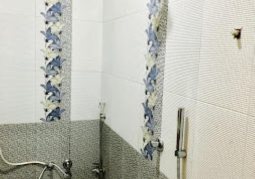 a bathroom with a shower and a mirror at Hotel Amba Amravati in Amrāvati