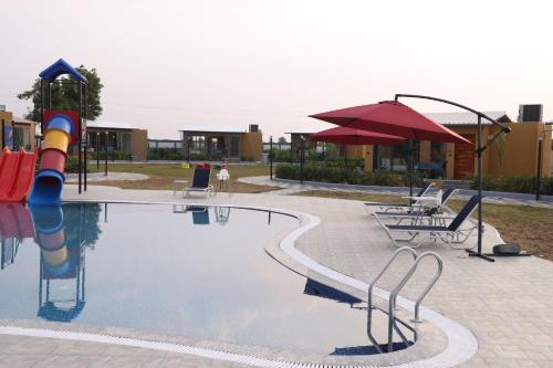 a swimming pool with a water slide and a playground at SKD RESORT AND CLUB in Barvāla
