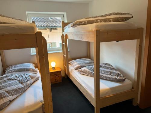 two bunk beds in a room with a window at Ferienwohnung Victoria in Brixen im Thale