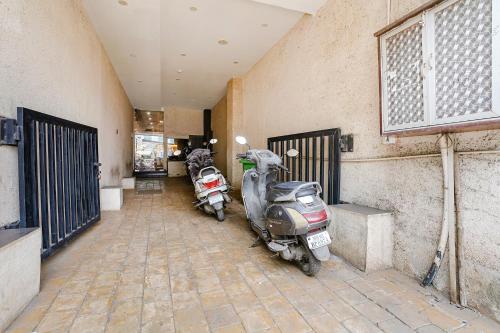 two scooters parked in a hallway next to a building at FabHotel Vertigo Suites - Nr BKC in Mumbai