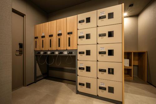 a room with a bunch of boxes on the wall at SAKURA PORT HOTEL in Kitakami