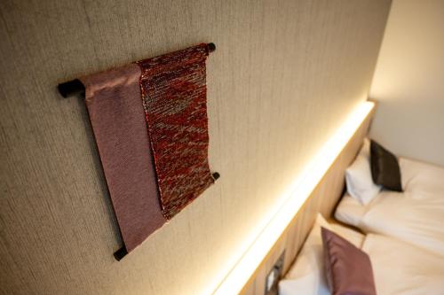 a red rag hanging on a wall in a room at SAKURA PORT HOTEL in Kitakami