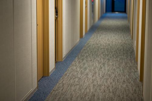 a hallway of an office building with a long aisle at SAKURA PORT HOTEL in Kitakami