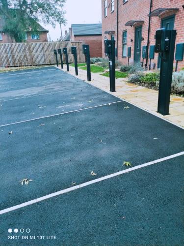 an empty parking lot with parking meters on a street at Dream Haute Homes in Nottingham