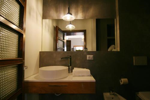 a bathroom with a sink and a mirror at La Rocca Guest House & Spa in Montefalco