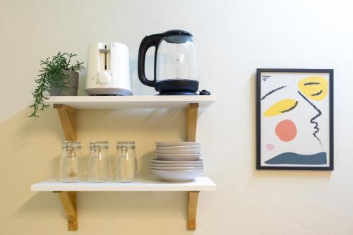 a shelf with dishes and a blender on a wall at 204hideaway-Local Room with Street Food only 15 min walk to Skytrain in Bangkok