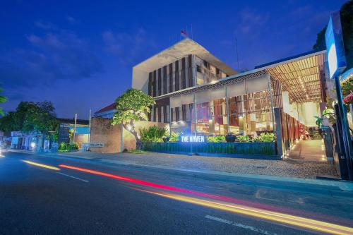 a building on the side of a street at night at THE HAVEN Bali Seminyak in Seminyak