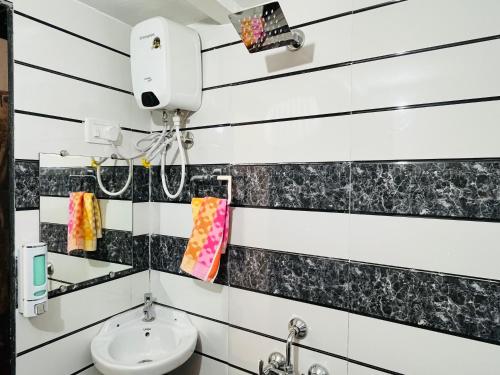 a bathroom with a toilet and a sink at Govardhan villas Farm Stay in Bijāpur