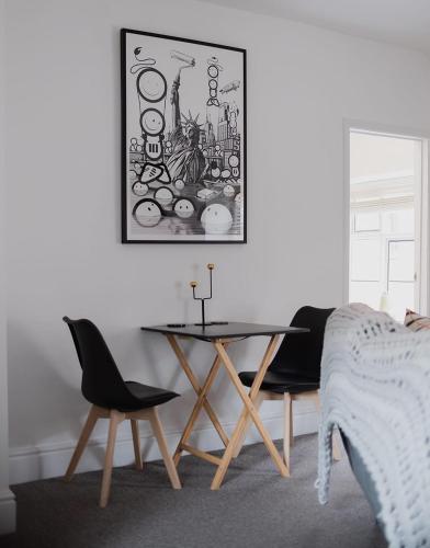 a dining room with a table and two chairs at No. 82 Grade II Listed Norwich City Centre Flat in Norwich