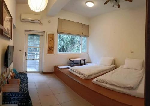 sypialnia z 2 łóżkami i oknem w obiekcie Rachels Inn w mieście Tongluo