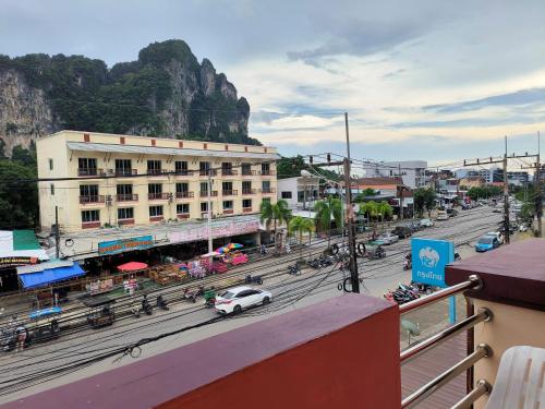 a view of a street with a building and a mountain at Aonang Goodwill in Ao Nang Beach