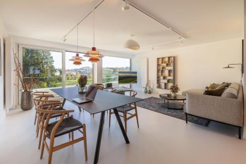 a dining room and living room with a table and chairs at Ferienhaus Daheim in Sankt Peter