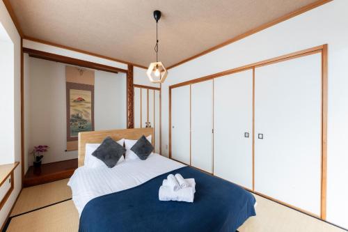 a bedroom with a bed with towels on it at The COMFORIA in Sapporo