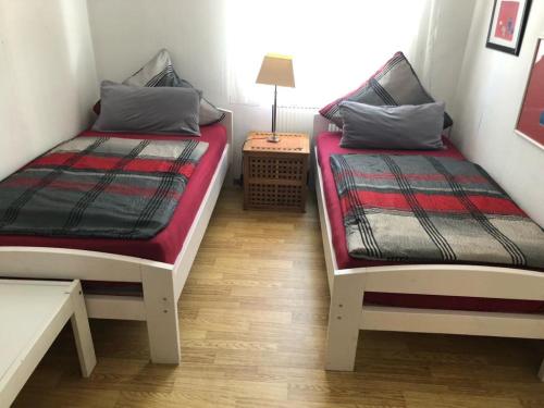 2 łóżka w małym pokoju ze stołem w obiekcie Steinhagen w mieście Daun