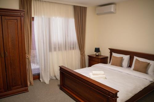 a bedroom with a large bed and a window at Motel Zeta Lux in Mitrovići