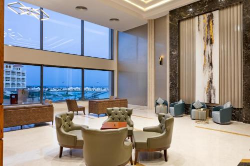 a lobby with a table and chairs and large windows at Xanadu Makadi Bay - High Class All Inclusive in Hurghada