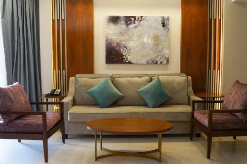 a living room with a couch and two chairs at Xanadu Makadi Bay - High Class All Inclusive in Hurghada