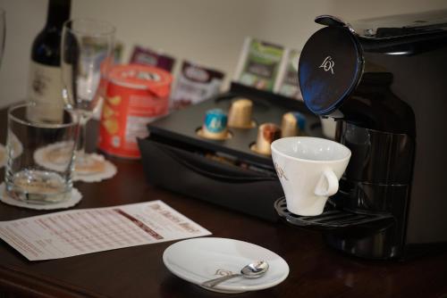 a coffee maker sitting on top of a wooden table at The Charles in Prague