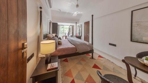 Cama o camas de una habitación en Villa Belle Vue- 4BHK Private Pool & Party Hall By StayMonkey