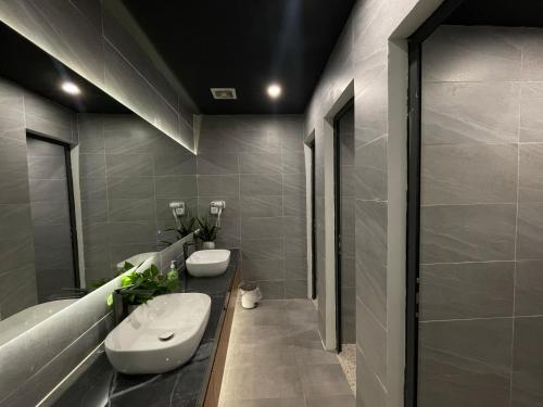 a bathroom with two sinks and a shower at Bông Hà Nội hostel in Hanoi