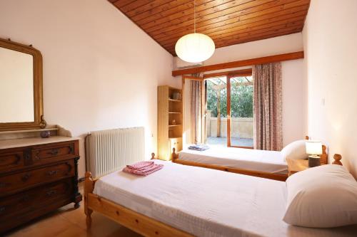 a bedroom with two beds and a window at Belle Epoque - Holiday Home in Aegina Town