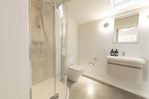 a bathroom with a shower and a toilet and a sink at Blackwood in Hornsea