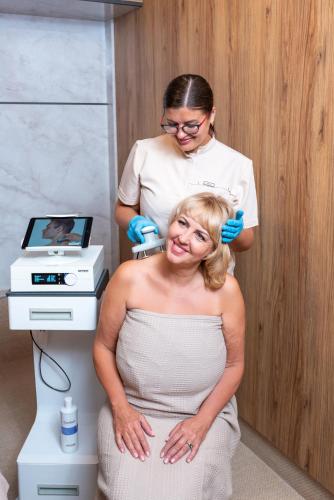 a woman getting her hair cut in a salon at Poseidon VIP Residence Club Balneo & SPA Resort in Nesebar