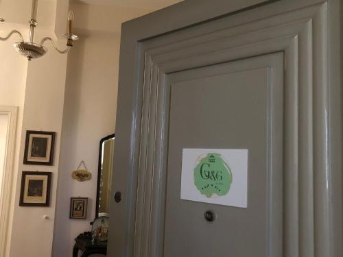 a door with a green sign on it at G&G ROOMS in Palermo