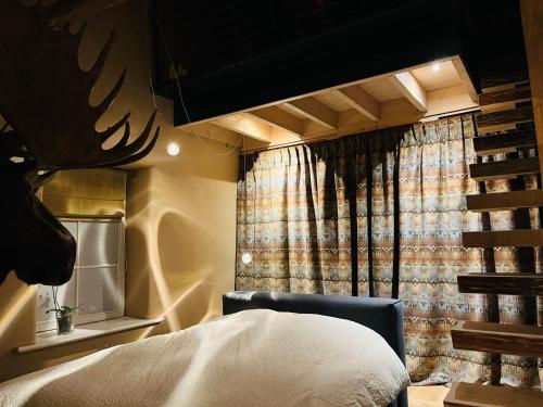 ein Schlafzimmer mit einem Bett und einem Stuhl und einem Fenster in der Unterkunft Maison Galerie Art n Pepper in Solwaster