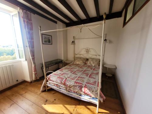 a bedroom with a bed with a metal frame at Maison confortable à Bardos avec vue sur montagne in Bardos