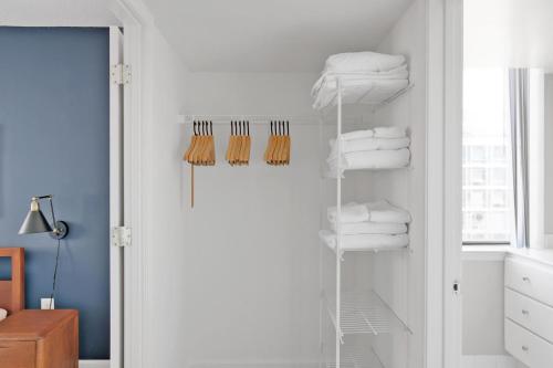 a bathroom with a closet with towels on a shelf at Mount Vernon 2BR w Gym WD Rooftop nr metro WDC-58 in Washington, D.C.