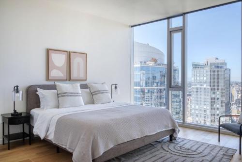 a bedroom with a large bed and a large window at Downtown 2BR w Gym WD BBQ nr Dining Shops SEA-634 in Seattle