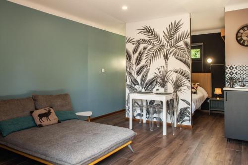 a living room with a couch and a bed at VILLA DREAM LANDES Piscine tempérée-Jacuzzi-5 suites parentales in Moliets-et-Maa