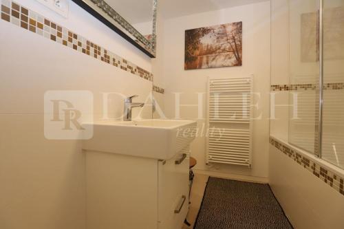 a bathroom with a sink and a shower at Einpark Fabulous Apartment with Private parking in Bratislava
