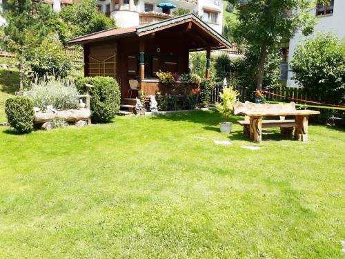 a backyard with a picnic table and a house at Haus Daniela in Gerlos