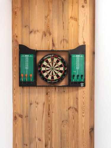 a dart board on a wooden wall at Moose Lodge in Sankt Anton am Arlberg