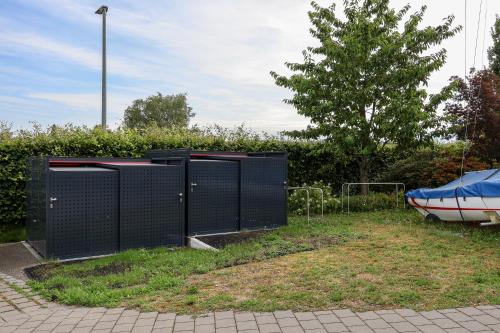 a pair of black gates with a boat in a yard at Ferienhaus Seezeichen in Wasserburg am Bodensee